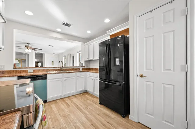 a kitchen with stainless steel appliances granite countertop a refrigerator and a sink