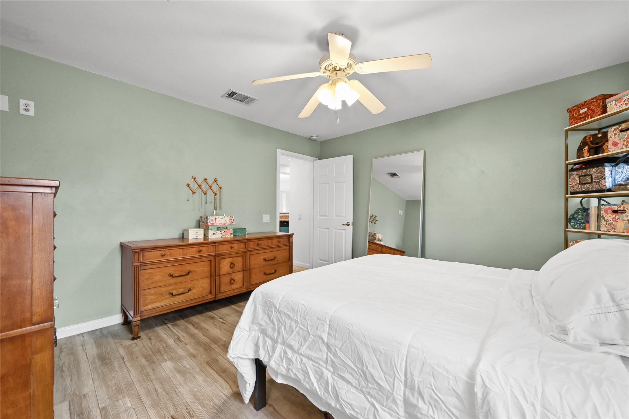 7620 Cayenne Lane Austin, TX 78741 - Photo 17 of 27 a bedroom with a bed and a chandelier