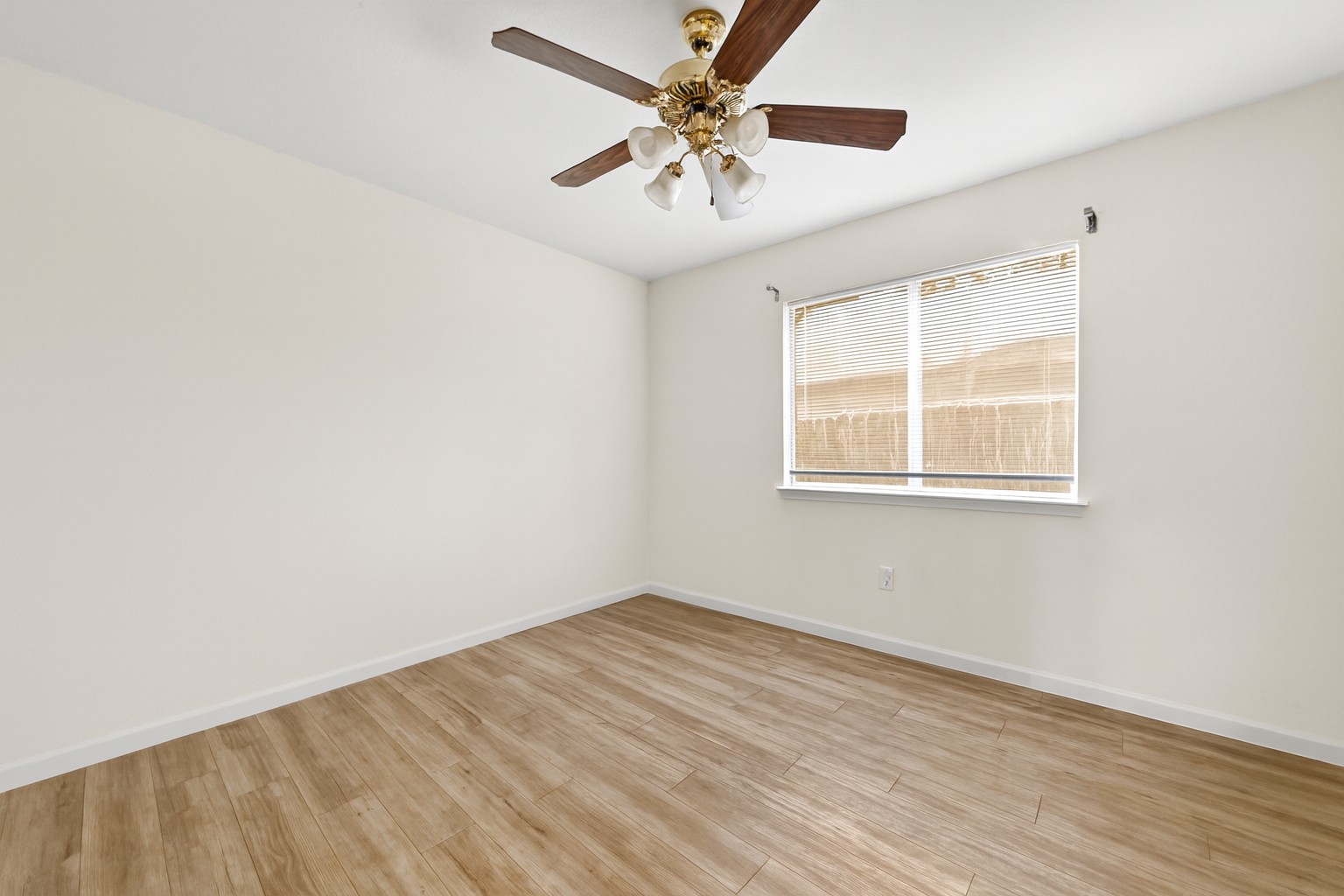 7620 Cayenne Lane Austin, TX 78741 - Photo 21 of 27 an empty room with a window and a ceiling fan