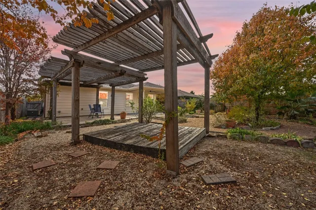 a view of a backyard with wooden fence