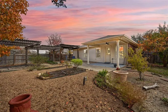 a view of a house with backyard and sitting area