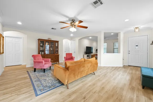 a living room with furniture and wooden floor