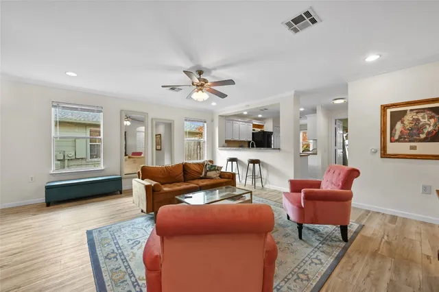a living room with furniture and a wooden floor