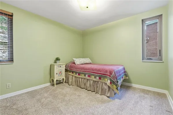 a spacious bedroom with a bed and a table in it