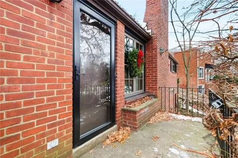 a view of a brick house with a large windows