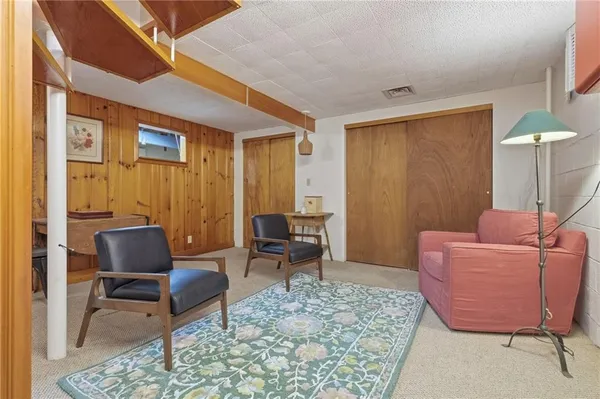 a living room with furniture and a rug