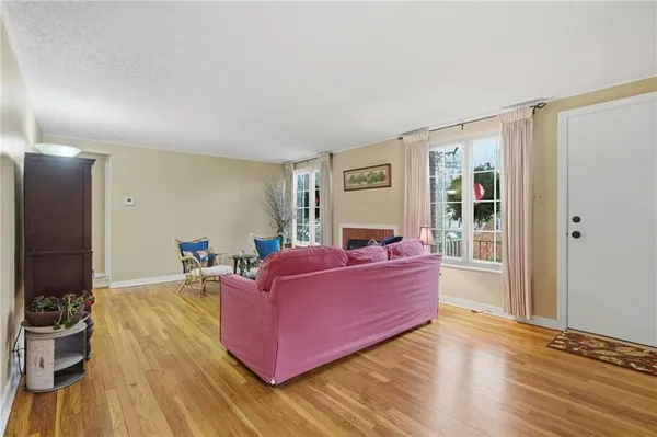 a living room with furniture window and wooden floor