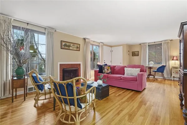 a living room with furniture a large window and a fireplace