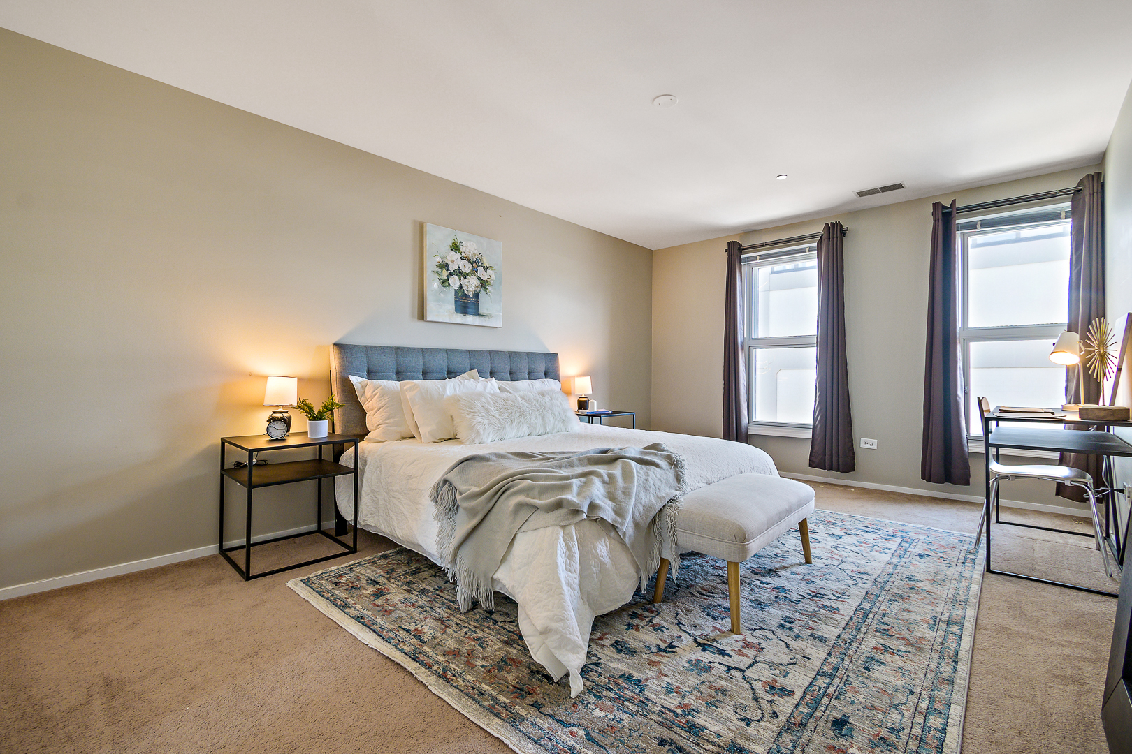 51 West 15th Street, Unit K2 Chicago, IL 60605 - Photo 16 of 28 a bed sitting in a spacious bedroom next to a window and a chair