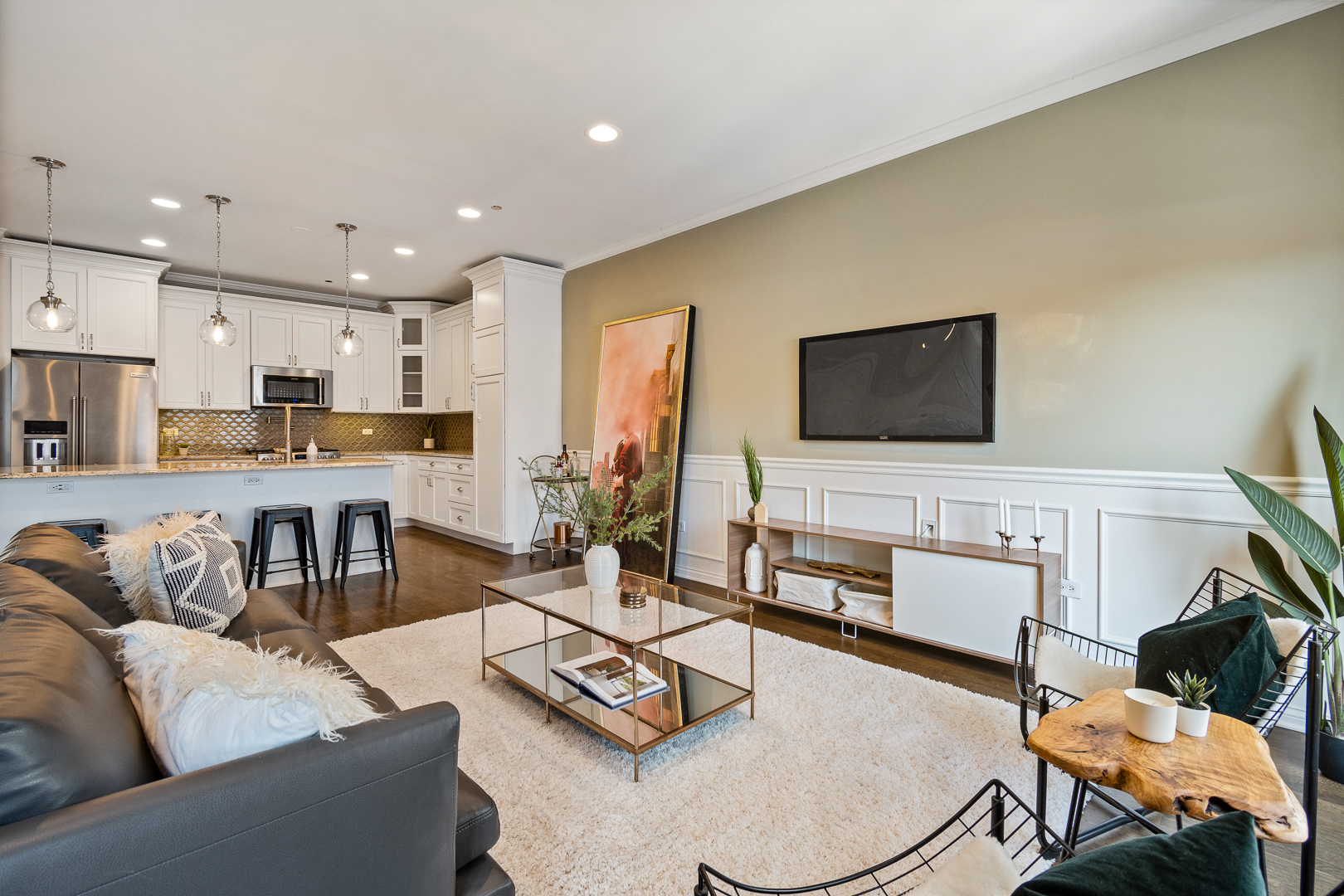 51 West 15th Street, Unit K2 Chicago, IL 60605 - Photo 4 of 28 a living room with furniture and a flat screen tv with kitchen view