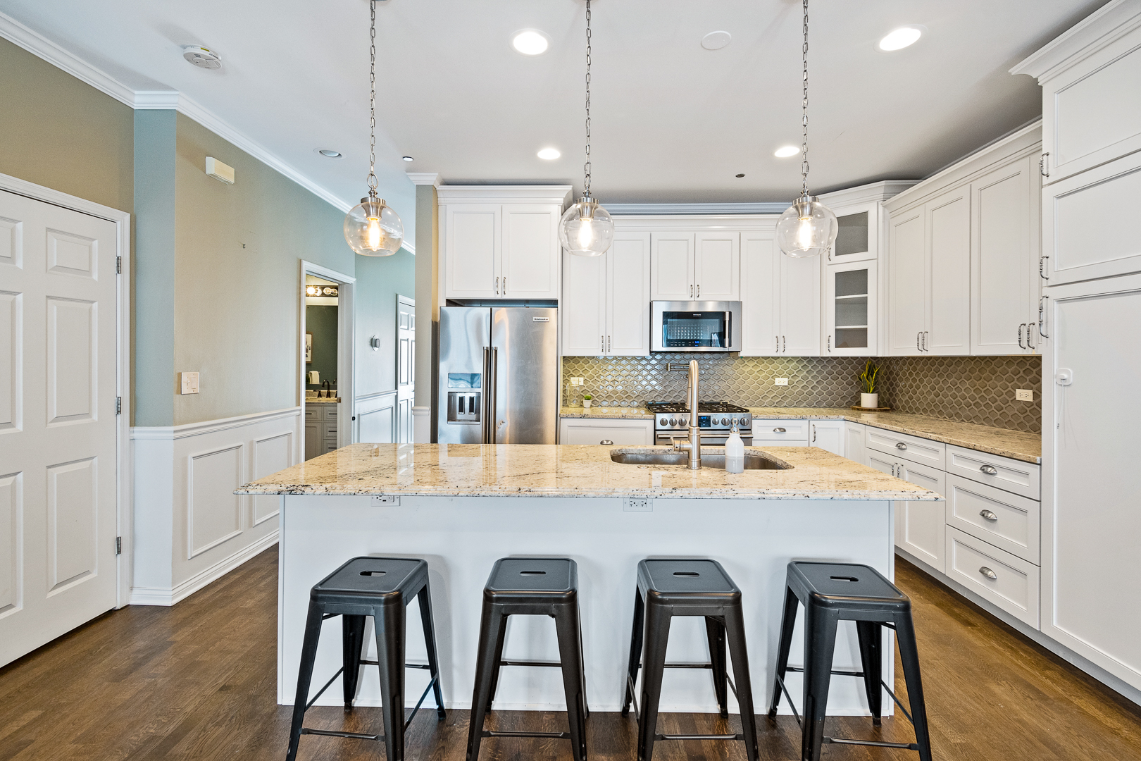 51 West 15th Street, Unit K2 Chicago, IL 60605 - Photo 9 of 28 a kitchen with stainless steel appliances granite countertop a dining table chairs refrigerator and cabinets