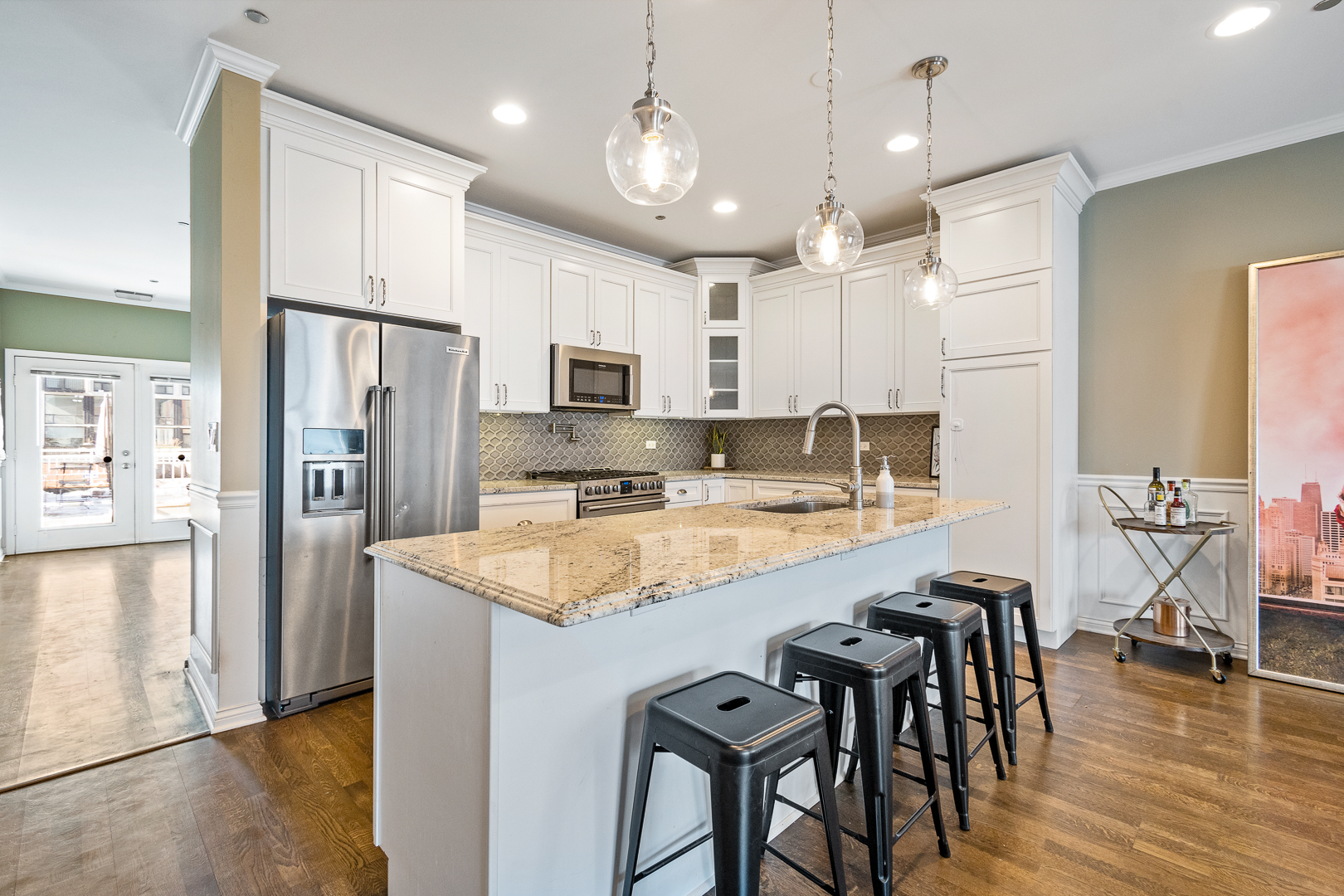 51 West 15th Street, Unit K2 Chicago, IL 60605 - Photo 10 of 28 a kitchen with stainless steel appliances granite countertop a table chairs refrigerator and microwave