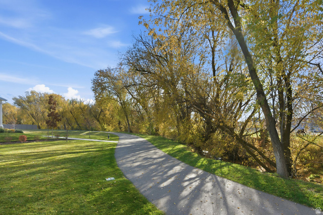 1038 South Old Towne Road Layton, UT 84041 - Photo 29 of 39 Paved pathway bordered by manicured lawn and mature trees with autumn foliage