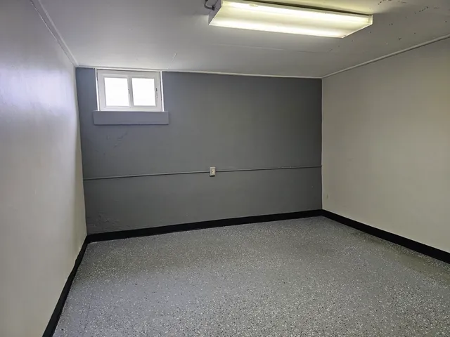 a bedroom with a bed and a chair in it