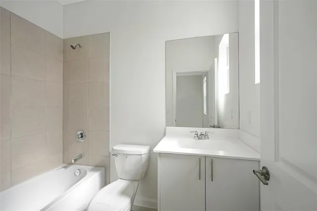 a bath tub sitting next to a white toilet