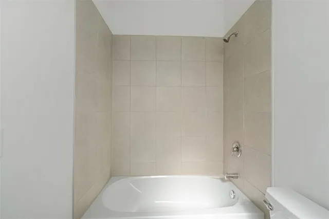 an empty room with a white cabinet and door