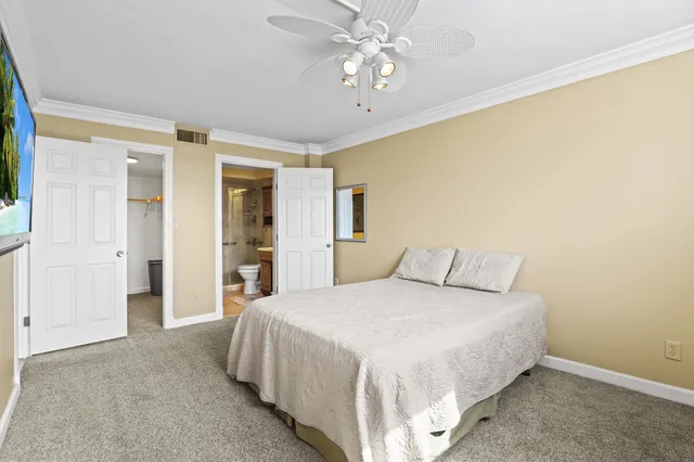 a spacious bedroom with a bed and a chandelier