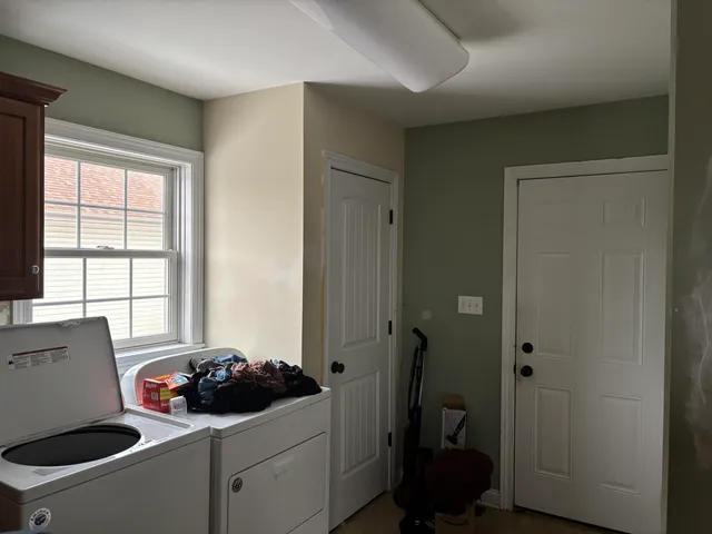 a room with a window and a washer dryer