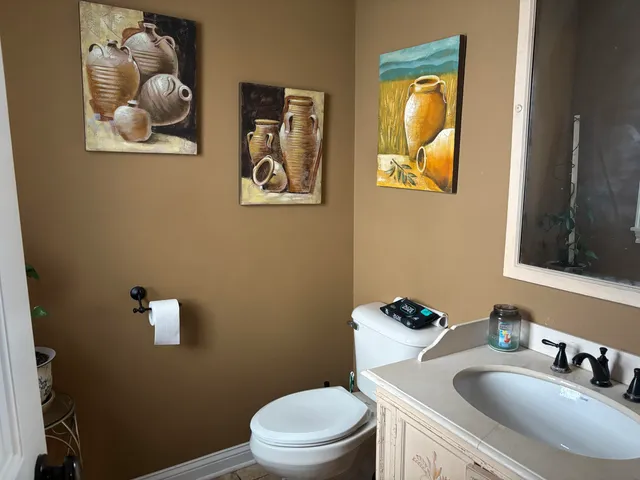 a bathroom with a toilet a sink and mirror