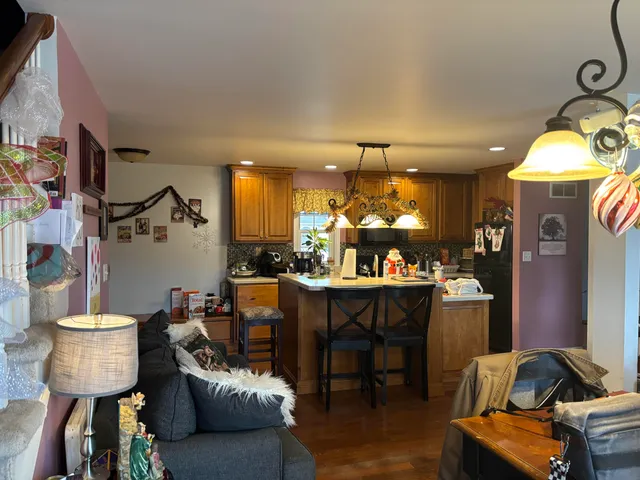 a living room with furniture and a chandelier