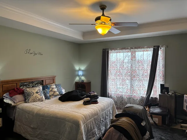 a bedroom with a bed and window