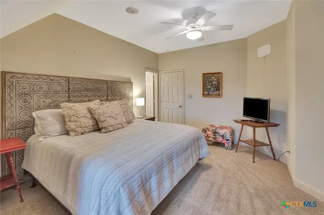 a living room with lots of furniture and a book shelf