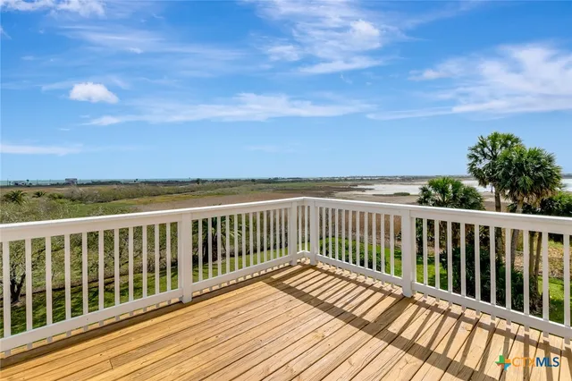 a living room with hardwood floor and a balcony