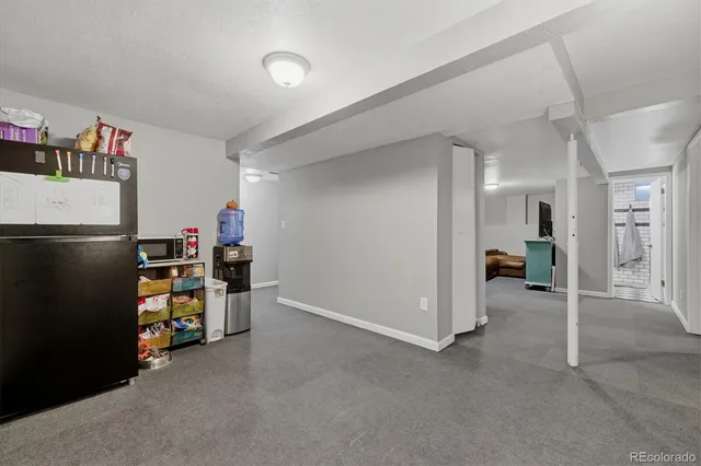 a view of a storage & utility room with refrigerator