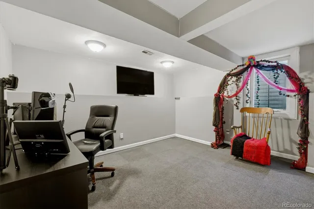 a view of a livingroom with workspace and a window