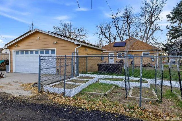 a backyard of a house with table and chairs