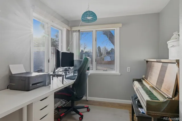 a view of a workspace with furniture and a window