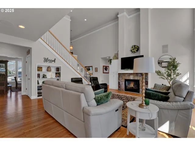 a living room with furniture a fireplace and a potted plant