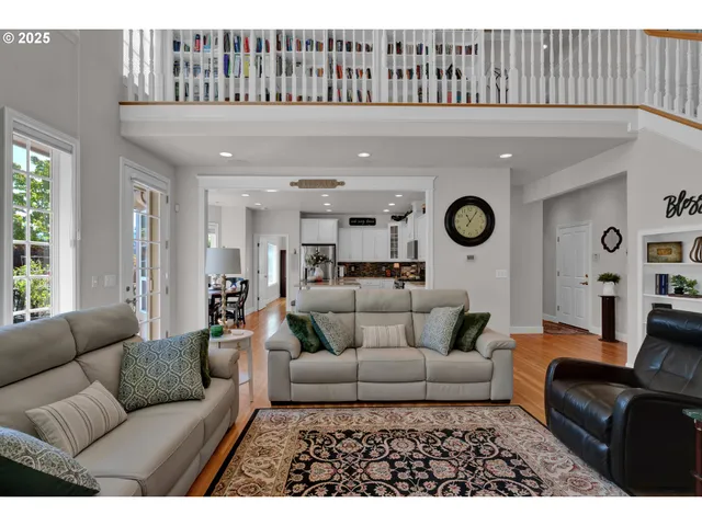 a living room with furniture and a clock