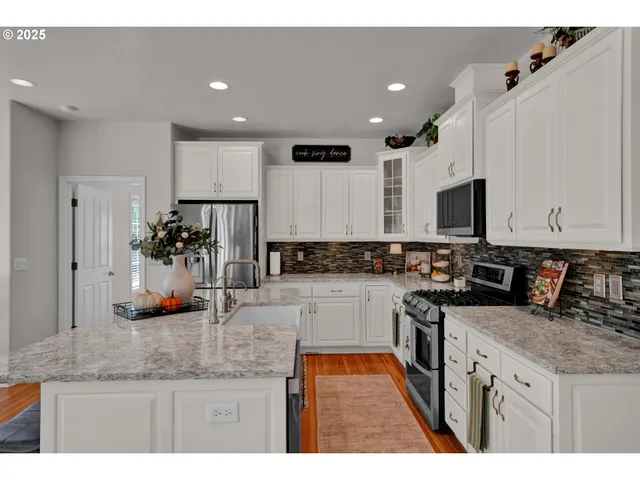 a kitchen with stainless steel appliances granite countertop counter space a sink and cabinets