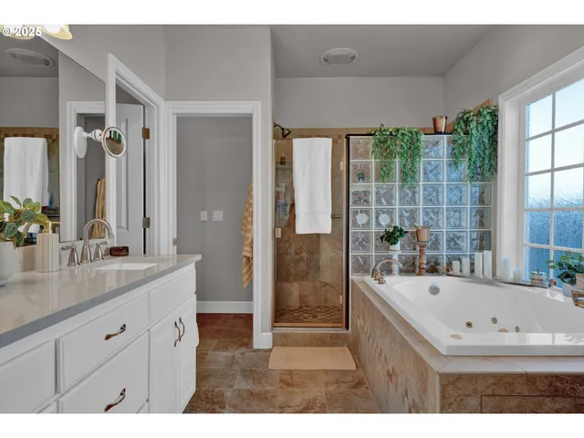 a bathroom with a tub sink and mirror