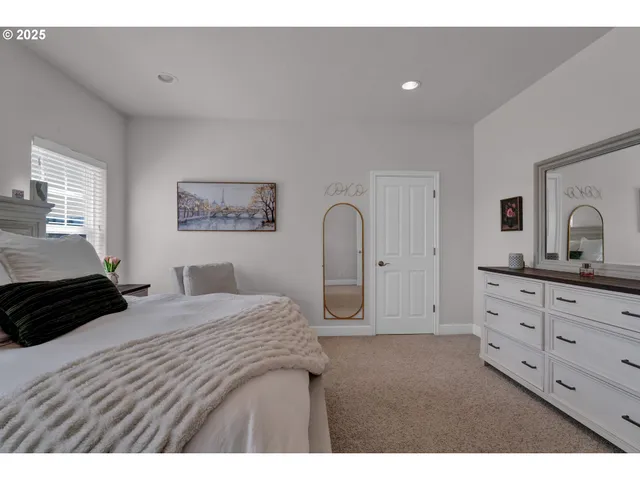 a bedroom with a bed and a dresser