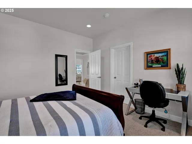 a bedroom with a bed and a desk