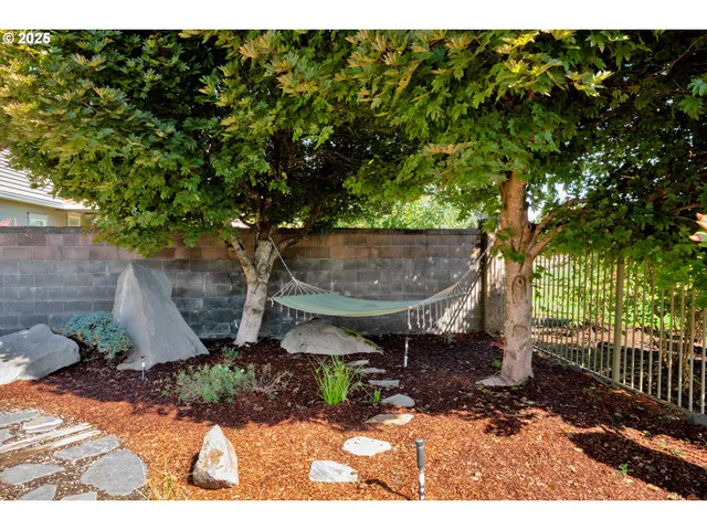 a backyard of a house with table and chairs