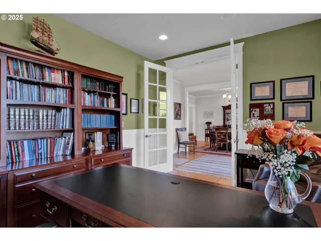 a living room with furniture and a book shelf