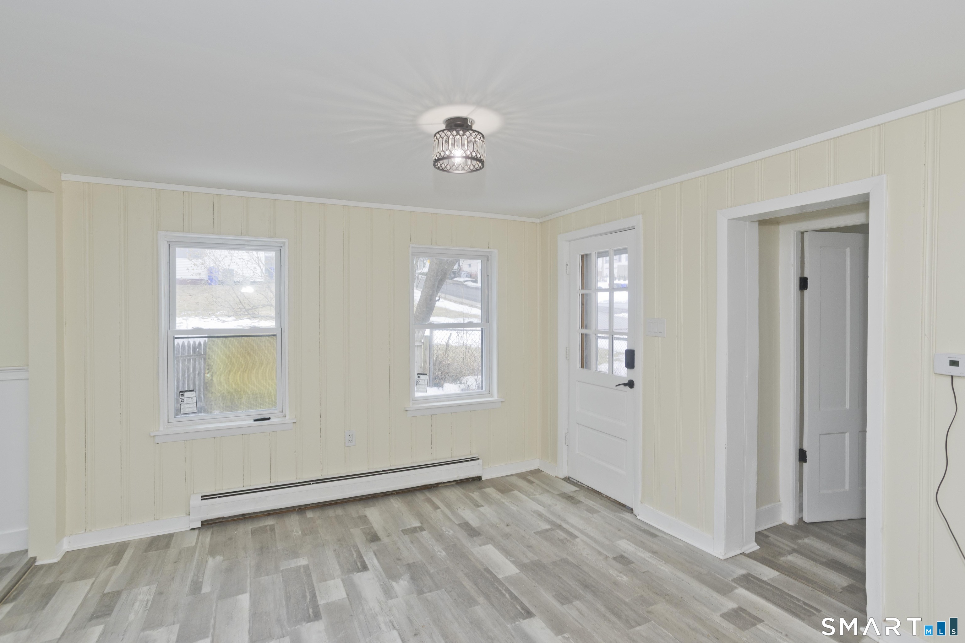 47 Maple Avenue Enfield, CT 06082 - Photo 35 of 36 a view of an empty room with wooden floor and a window