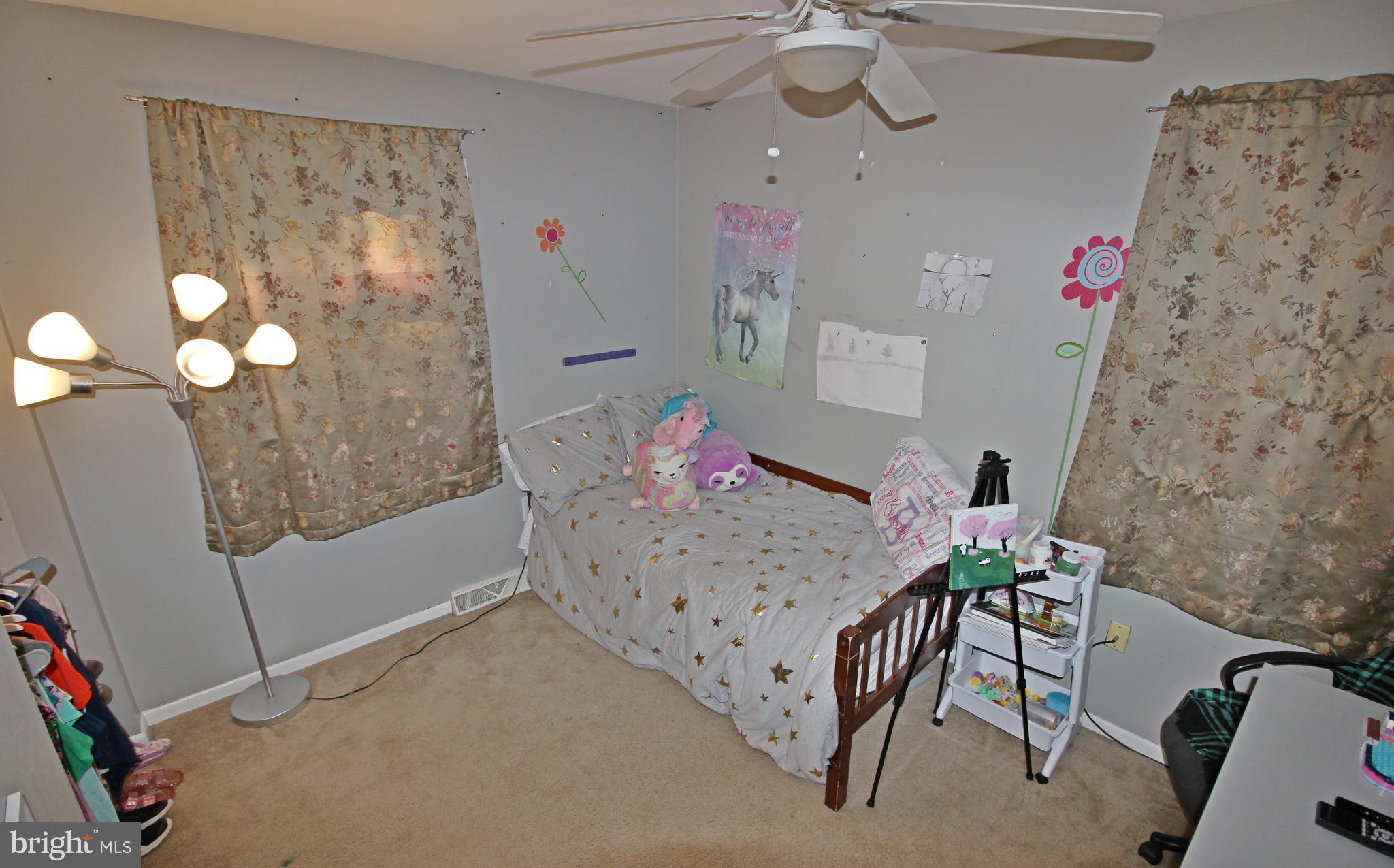 208 Cardinal Road Lititz, PA 17543 - Photo 23 of 40 a bedroom with a bed and a chandelier