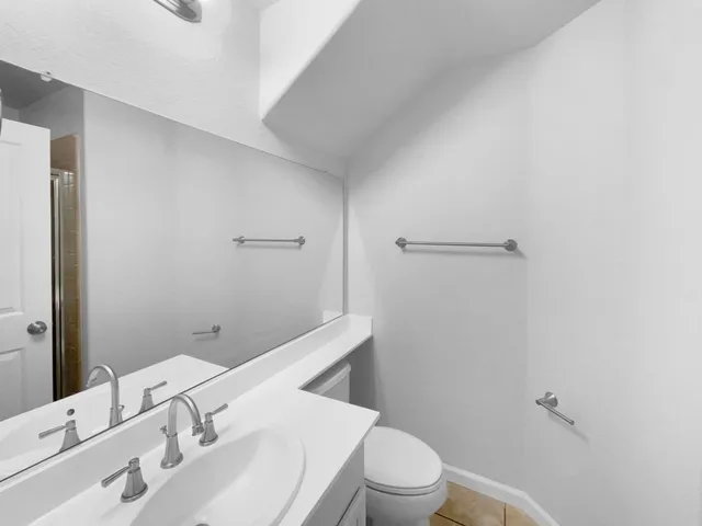 a bathroom with a sink toilet and vanity