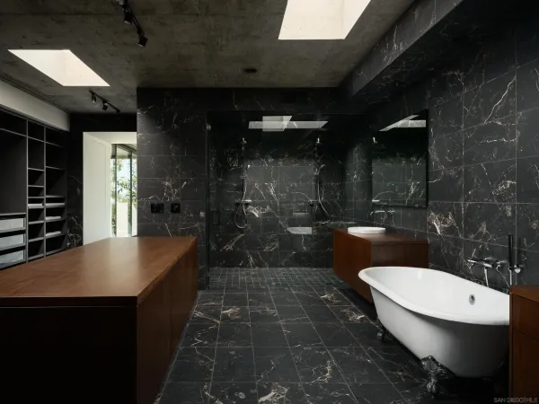 a bathroom with a sink a toilet a mirror and shower