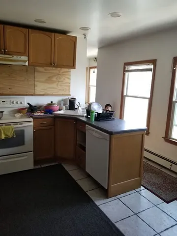 a kitchen with sink cabinets and stainless steel appliances