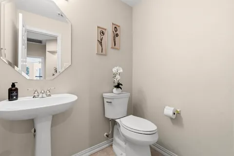 a bathroom with a sink mirror and toilet