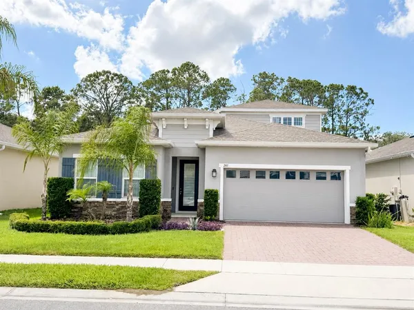 a front view of a house with a yard and a garage