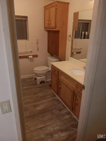 a bathroom with a sink a toilet and mirror