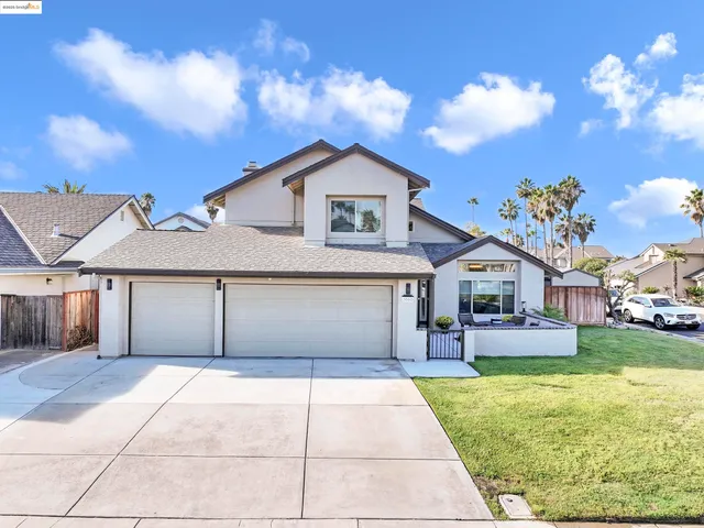 a front view of a house with a yard and a garage