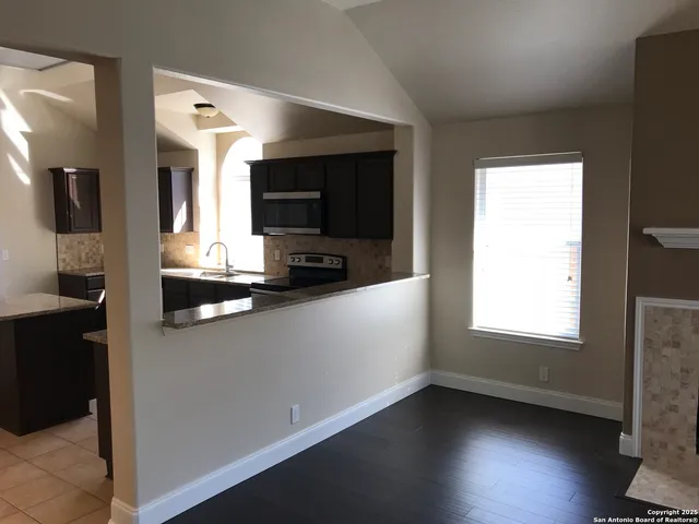 a kitchen with stainless steel appliances a microwave sink and refrigerator