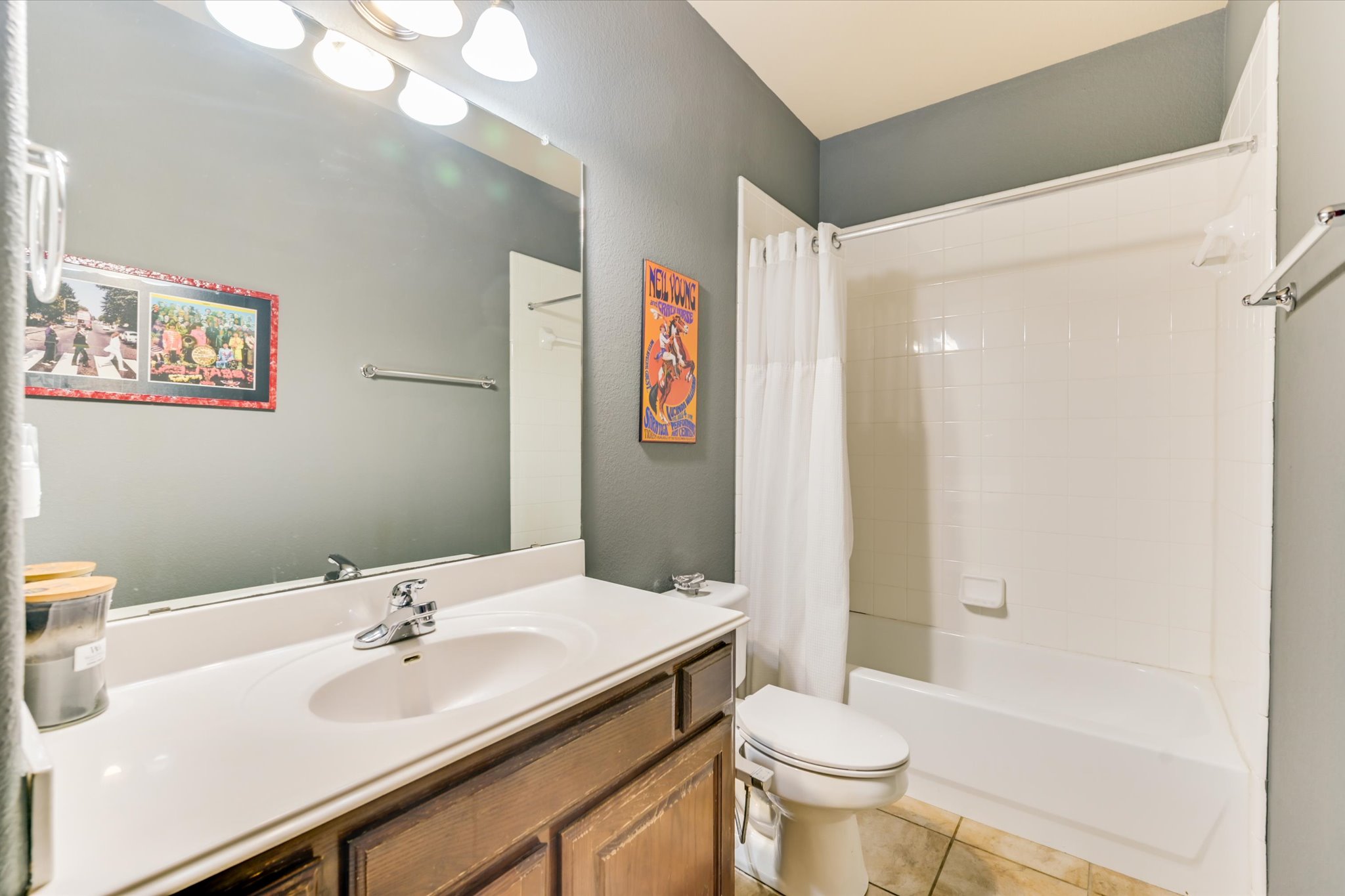786 Ranchers Club Lane Driftwood, TX 78619 - Photo 23 of 33 Bathroom with shower / bath combination with curtain, light tile patterned floors, vanity, and a textured wall